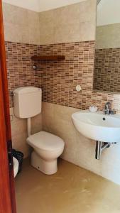 a bathroom with a toilet and a sink at Hotel Lima in Lido di Savio
