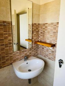 a bathroom with a white sink and a mirror at Hotel Lima in Lido di Savio