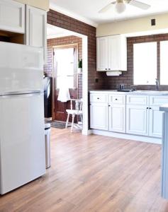 a kitchen with white cabinets and a white refrigerator at 3 bedroom country home pet friendly in Monroe