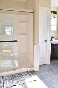 a glass shower in a bathroom with a sink at 3 bedroom country home pet friendly in Monroe