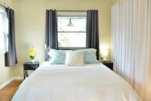 sypialnia z dużym białym łóżkiem i oknem w obiekcie 3 bedroom country home pet friendly w mieście Monroe