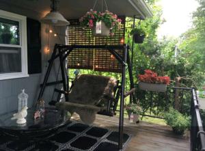 a screened porch with a chair and a glass table at 3 bedroom country home pet friendly in Monroe