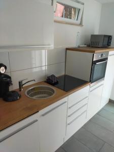 a kitchen with a sink and a counter top at Ferienwohnungen Recklinghausen-Nord in Recklinghausen