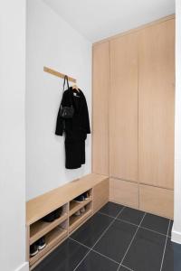 a walk in closet with a black tiled floor at Demims Apartments Oslo -- Cozy, Central & Stylish in Oslo