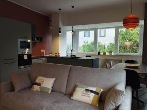 a living room with a couch and a kitchen at A casa di Twiggy in Bologna +42 photos