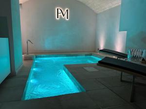a swimming pool with blue water in a room at Palazzo Mulini in Monopoli
