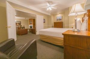 a hotel room with a bed and a desk and a chair at Multi Resorts at Lift Lodge in Park City