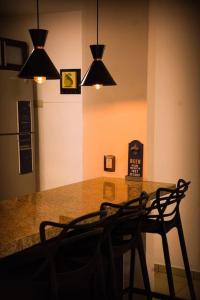 a kitchen with a table with chairs and lights at Cielito Home in Jesús María