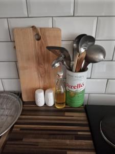 a kitchen counter with a container of kitchen utensils at Little Dorrit Studio flat Rochester ME1 1XZ in Strood