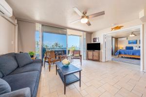 a living room with a couch and a table at Island Surf 601B in Kihei