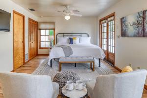 a bedroom with a bed and two chairs at 62 Hypolita Carriage House in Saint Augustine