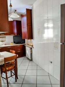 a kitchen with a table and a refrigerator and a counter at Appartamento Dimora dei marchi in Cosenza