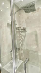 a shower with a glass door in a bathroom at Classic Hyde Park Hotel in London