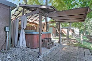 a pergola with a hot tub in a backyard at Waterfront Cabin overlooking Potomac w/ Hot tub 