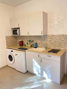 a kitchen with a sink and a washing machine at Haifa boutique apartment by LIME in Haifa