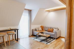 a living room with a couch and a table at Apartamenty Schronisko Snów in Bukowina Tatrzańska +71 photos