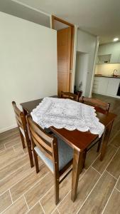 a dining room table with a white table cloth on it at Depto a pasos del centro de Puerto Montt in Puerto Montt