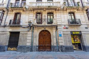 a building with a large wooden door on a street at Casual Blue in Bilbao