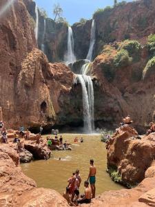 a group of people in the water at a waterfall at Dar Khalti - Cascades - Piscine - Montagne in Ouzoud