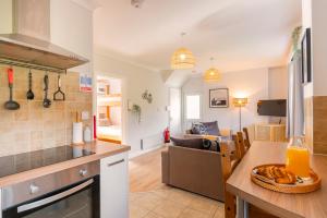 a kitchen and a living room with a table at The Peak by Afan Valley Escapes in Cymmer