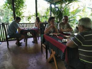 a group of people sitting at tables in a restaurant at Gangula Eco lodge in Sigiriya