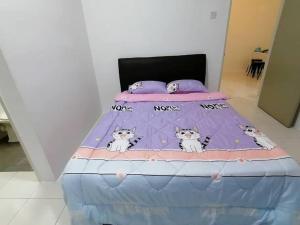 a bed with four cats on it at Cameron Hill Homestay in Tanah Rata