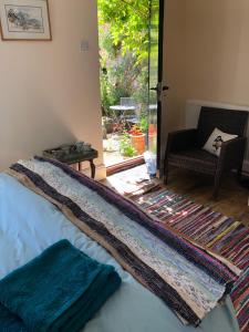 a blanket laying on top of a bed in a room at Southernhay in Beer
