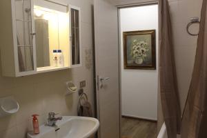 a bathroom with a sink and a mirror at Arona il Passaggio in Arona