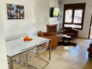 a living room with a table with a bowl of fruit on it at Gound Floor Bungalow Jumilla III Playa Flamenca in Orihuela Costa