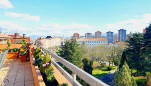 a balcony with a view of a city at La Luz de Acevedo in Oviedo