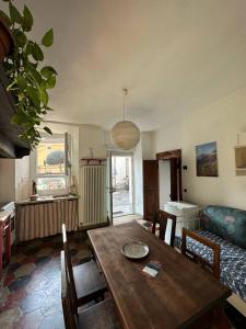 a living room with a wooden table and a couch at Casa Sasso e Legno in Omegna
