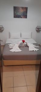 a bed with two women in white dresses on it at ZANIA in Rethymno