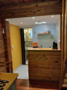 a kitchen with a wooden counter in a room at La Cabaña in Tandil +28 photos
