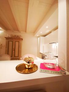 a bowl on a plate on a kitchen counter at Gombruti14 Boutique Home in Bologna +53 photos