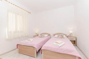 Postel nebo postele na pokoji v ubytování Apartments Silvana