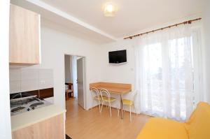 a kitchen and dining room with a table and chairs at Apartments Josko in Gradac