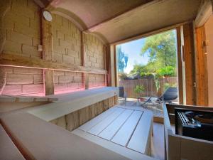 a tiny house is being built with a large window at Hotel-Pension Seebad "Seegenuss-Natur-Spa" in Sulzberg