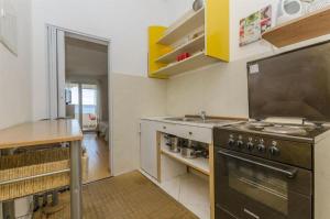 a kitchen with a stove and a sink at Apartments Zanet in Sumpetar