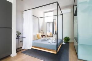 a bedroom with a canopy bed with a mirror at Stay In Ortigia in Siracusa
