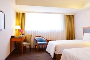 Postel nebo postele na pokoji v ubytování Fuward Hotel Tainan
