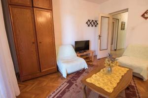 a living room with a bed and a coffee table at Apartments Luka in Mali Lošinj