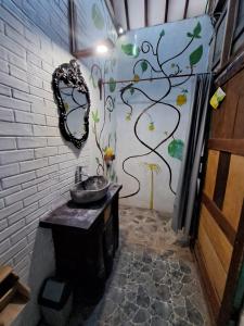 a bathroom with a sink and a mirror on the wall at Diana's Homestay in Banyuwangi