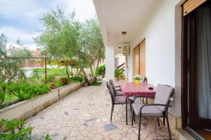 a patio with a table and chairs on a patio at Apartments Ivanka in Krk