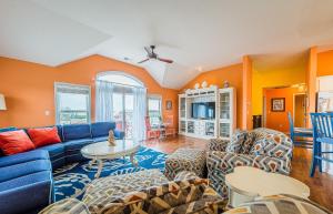 a living room with a blue couch and chairs at K2095 Clam I Am. Semi-Oceanfront, Elevator, Private Pool, Rec Room, Theater in Southern Shores