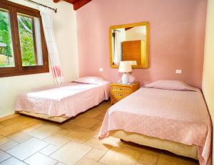 ドームス・デ・マリーアにあるCase Vacanza Bithiaのベッドルーム1室(ベッド2台、鏡付)