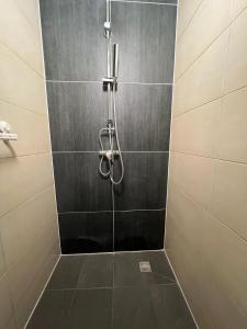 a shower with a glass door in a bathroom at Kiez Box TwentyForSeven private room in Berlin