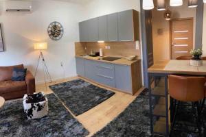 a kitchen and living room with a couch and a table at Luma Exclusive in Osijek +28 photos