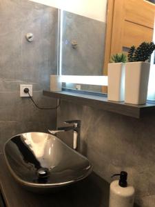 a bathroom with a sink and a mirror at Luma Exclusive in Osijek