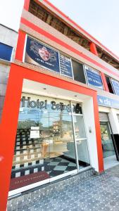 a store front of a hotel building with a window at Hotel Beijing Caucasia in Caucasia