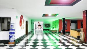 a hallway with a checkered floor in a building at Hotel Beijing Caucasia in Caucasia